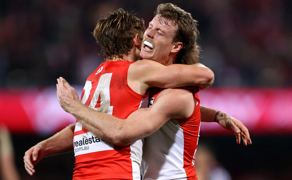 Sydney Swans players celebrate.