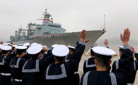 Soldiers of Chinese People's Liberation Army see off a fleet before it sets out for Aden, Yemen, from Zhoushan, Zhejiang province, April 3, 2015. REUTERS/Stringer