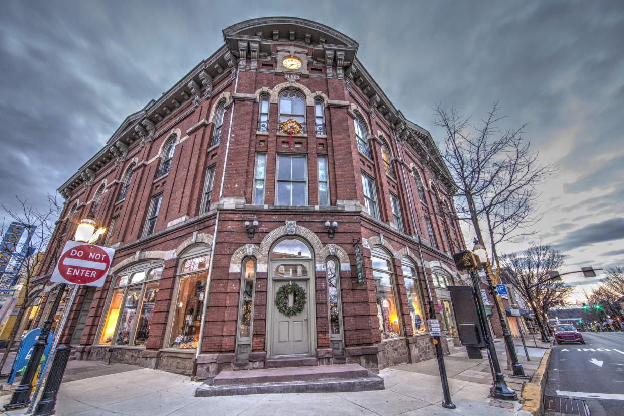 Victorian building with store front, center of Doylestown, Bucks County, Pennsylvania, fisheye lens view during the Christmas season, against a dramatic winter sky, bare trees