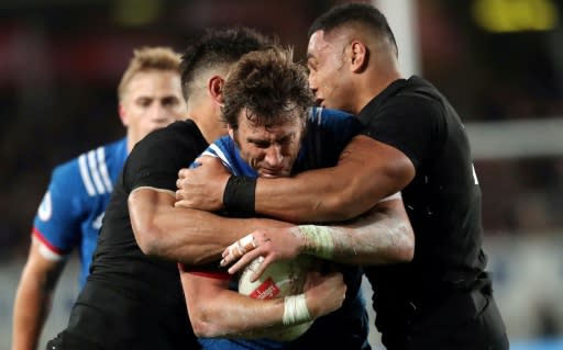 France's Maxime Medard is tackled by New Zealand's Anton Lienert-Brown (L) and Ngani Laumape during their first rugby union Test match, at Eden Park in Auckland, on June 9, 2018