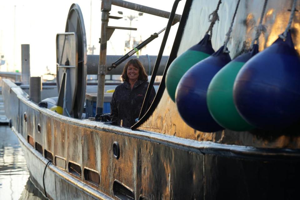 Ellie Kinley, a member of the Lummi (Lhaq’temish) Nation, stands on her fishing boat in Bellingham Bay’s Squalicum Harbor on Nov. 17, 2023. Kinley is the last Indigenous reef net permit holder of the ancient salmon fishing practice but didn’t use her reef netting rig this year due to economic realities.