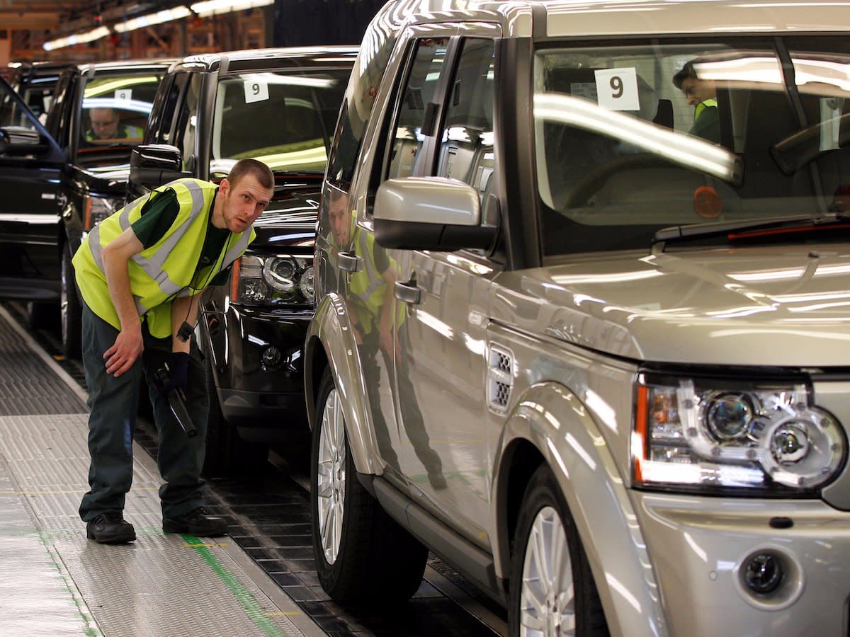 A worker inspects a Land Rover Discovery on the production line at their factory in Solihull, central England, February 28, 2012.