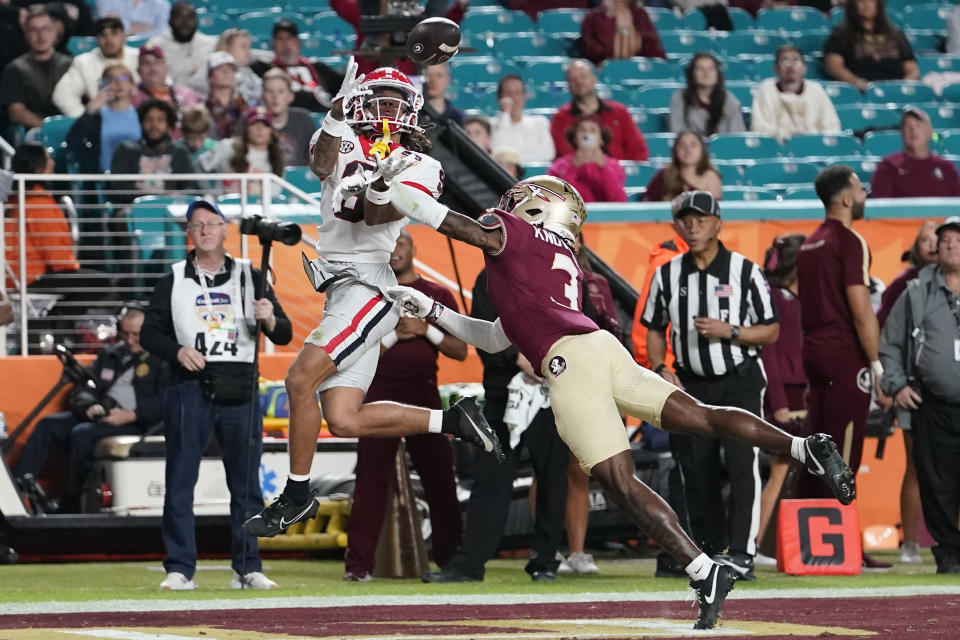 Georgia wide receiver Jackson Meeks (9) catches a pass for a touchdown as Florida State defensive back Kevin Knowles II (3) defends during the second half of Orange Bowl NCAA college football game, Saturday, Dec. 30, 2023, in Miami Gardens, Fla. (AP Photo/Lynne Sladky)