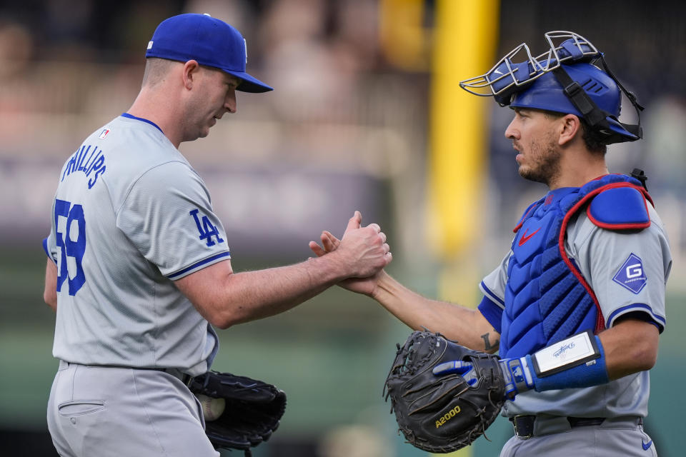 Los Angeles Dodgers pitcher Evan Phillips, left, and catcher Austin Barnes celebrate the team's win in a baseball game against the Washington Nationals, at Nationals Park, Thursday, April 25, 2024, in Washington. (AP Photo/Alex Brandon)