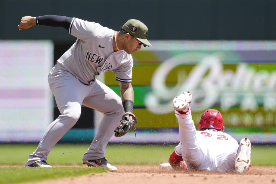 Cincinnati Reds' Luke Maile (22) steals second base against New York Yankees second baseman Gleyber Torres in the fifth inning of a baseball game in Cincinnati, Sunday, May 21, 2023. (AP Photo/Jeff Dean)