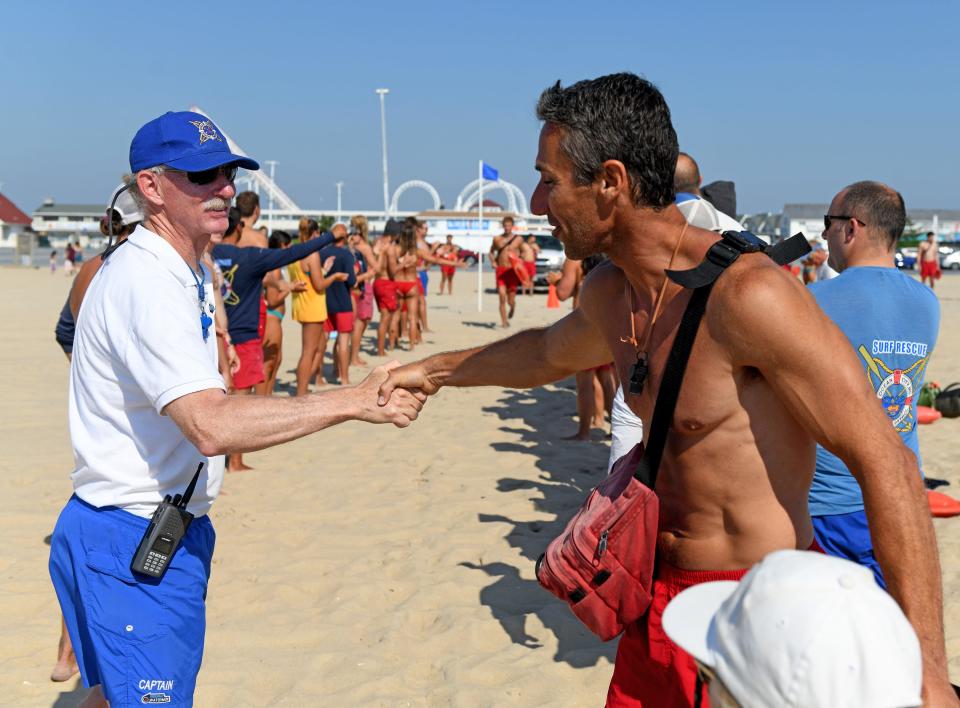 Andy Friedman of Waynesboro shakes hands with Ocean City Beach Patrol Captain Butch Arbin for graduation June 30, 2022, in the Maryland resort town.