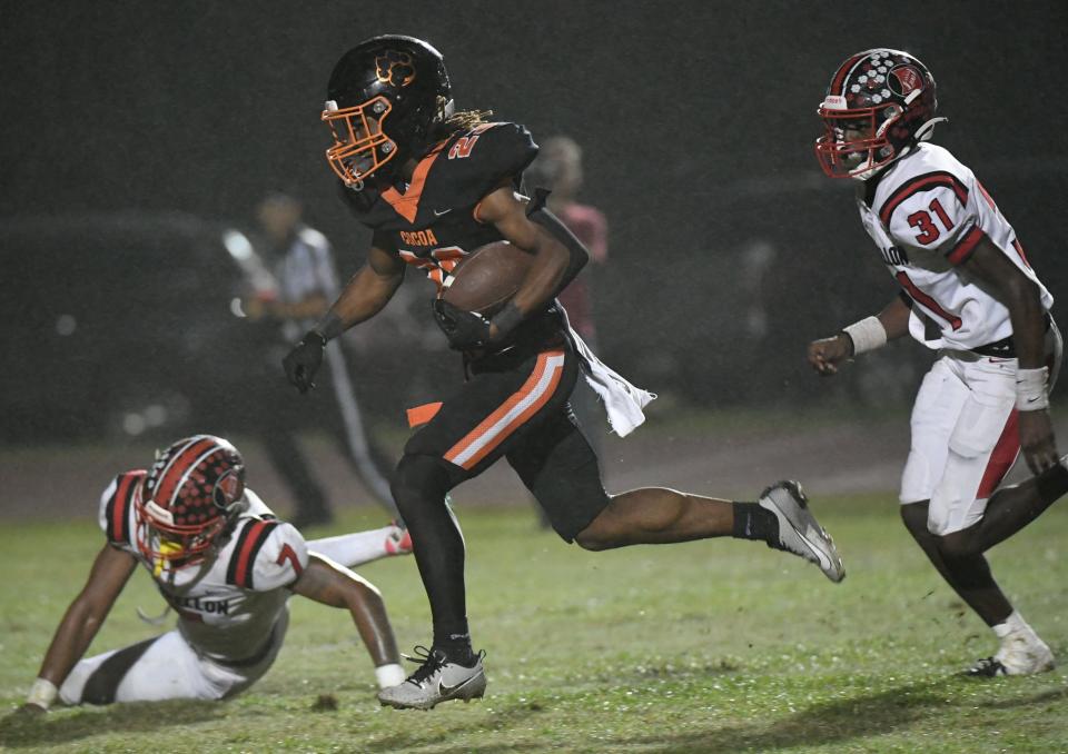 Latrison Lane of Cocoa gets past Chris Henry and Elijah Townes of Dunnellon and goes 30 yards for a touchdown in the FHSAA football playoffs Friday, November 17, 2023. Craig Bailey/FLORIDA TODAY via USA TODAY NETWORK