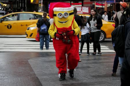 A Minion character dressed in a Christmas theme is pictured in Times Square during unseasonably warm weather on Christmas Eve in the Manhattan borough of New York, December 24, 2015. REUTERS/Carlo Allegri