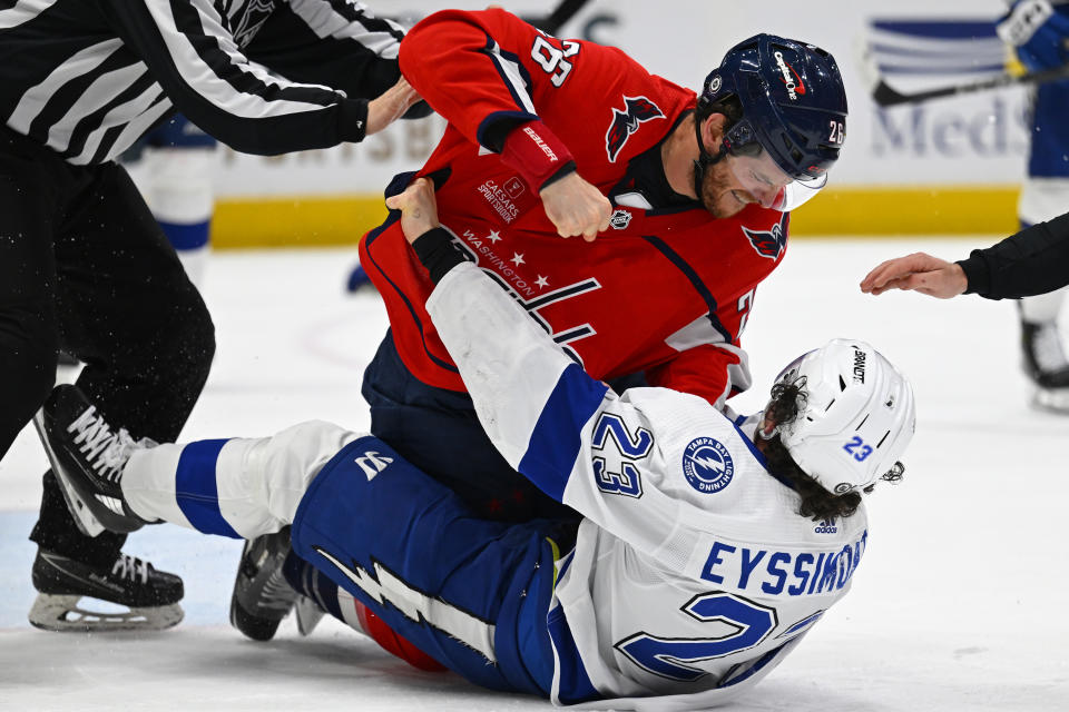 Washington Capitals center Nic Dowd (26) fights with Tampa Bay Lightning center Michael Eyssimont (23) during the second period of an NHL hockey game Saturday, April 13, 2024, in Washington. (AP Photo/John McDonnell)