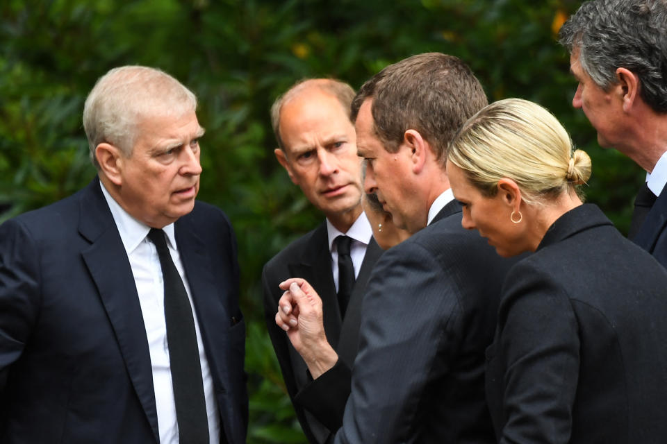 Britain's Prince Andrew, Duke of York (L), Britain's Prince Edward, Earl of Wessex, (2L) and Britain's Princess Anne, Princess Royal talk as they gather with Peter Phillips (C), Zara Phillips (2R) and Vice Admiral Timothy Laurence look at the flowers placed outside Balmoral Castle in Ballater, on September 10, 2022, two days after Queen Elizabeth II died at the age of 96. - King Charles III pledged to follow his mother's example of 