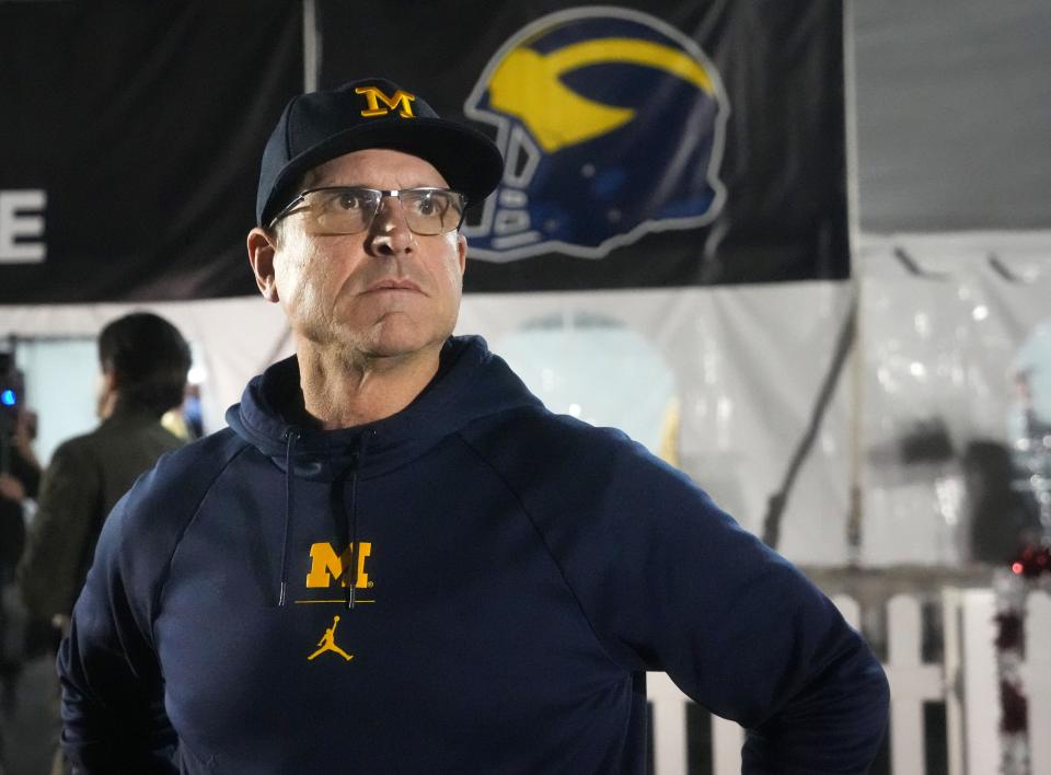 Michigan Wolverines head coach Jim Harbaugh srrives with his football team at Sky Harbor International Airport on Monday, Dec. 26, 2022, ahead of their College Football Playoff Semifinal at the Vrbo Fiesta Bowl against the TCU Horned Frogs. 