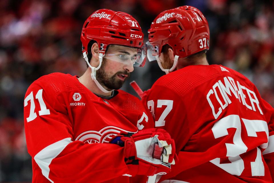 Red Wings center Dylan Larkin, left, talks to left wing J.T. Compher before a face-off against the Islanders during the third period of the Wings' 5-3 loss on Thursday, Feb. 29, 2024, at Little Caesars Arena.