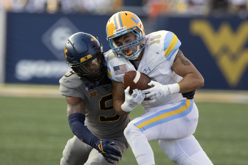 Long Island wide receiver Steven Chambers, right, is defended by West Virginia cornerback Charles Woods (9) during the first half of an NCAA college football game in Morgantown, W.Va., Saturday, Sept., 11, 2021. (AP Photo/Kathleen Batten)