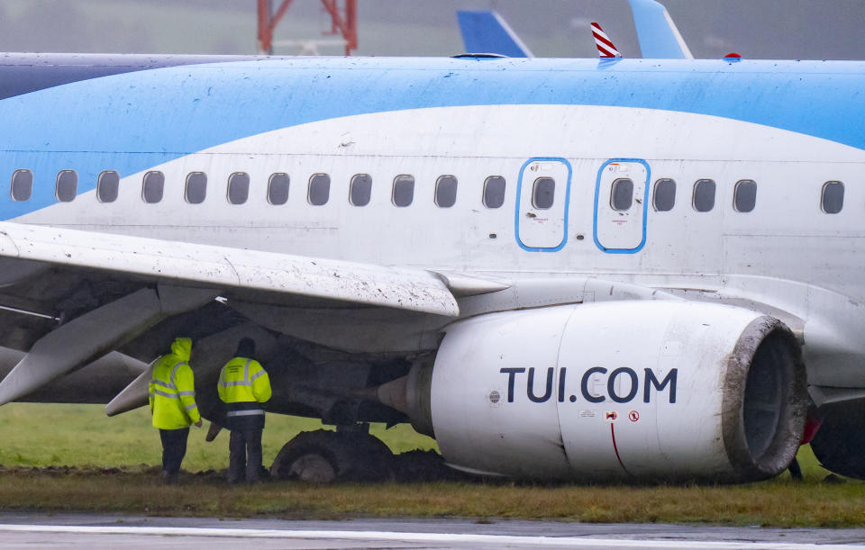 Emergency services at the scene after a passenger plane which came off the runway while landing in windy conditions at Leeds Bradford Airport, Leeds, England, Friday, Oct. 20, 2023. (Danny Lawson/PA via AP)