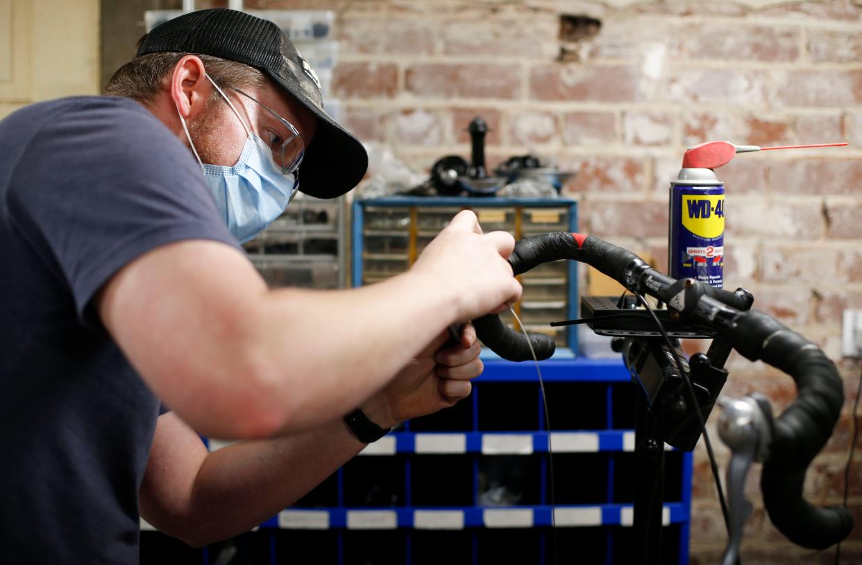 Kenneth Donnalley works on a bike at the Springfield Brewing Company Community Bike Shop at the Fairbanks on Monday, May 3, 2021.