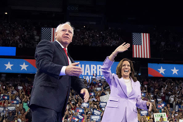 Kamala Harris, right, and Tim Walz gesture during a campaign rally at the Thomas and Mack Center, University of Nevada in Las Vegas, Nevada, on August 10, 2024.