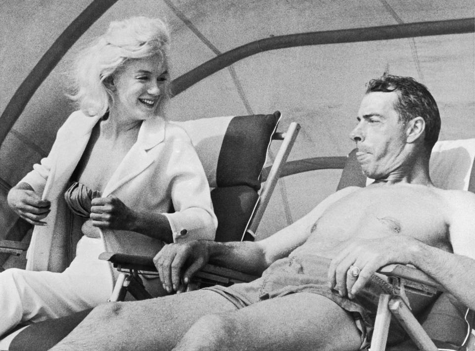 <p>Marilyn Monroe and Joe DiMaggio relax during New York Yankee spring training in 1961. </p>