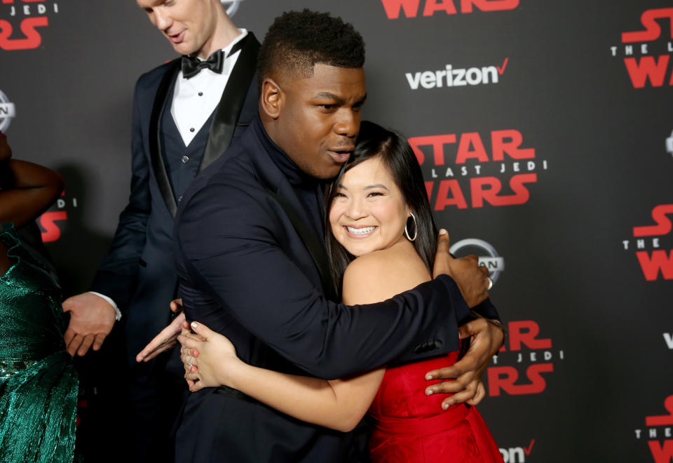 John Boyega and Kelly Marie Tran embrace on the carpet. (Photo: Jesse Grant/Getty Images for Disney)