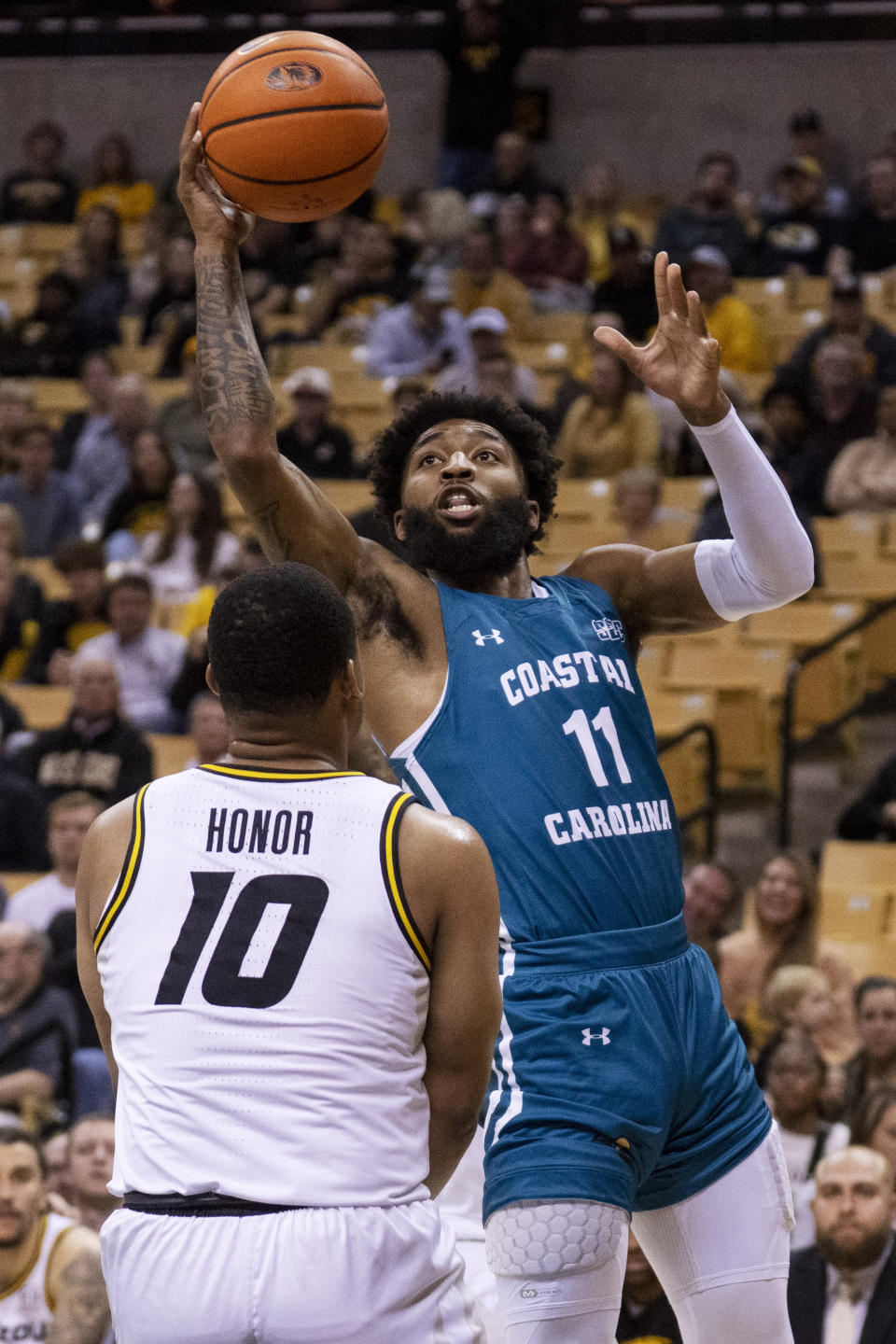 Coastal Carolina's Jomaru Brown, right, shoots over Missouri's Nick Honor, left, during the first half of an NCAA college basketball game Wednesday, Nov. 23, 2022, in Columbia, Mo. Missouri won 89-51. (AP Photo/L.G. Patterson)