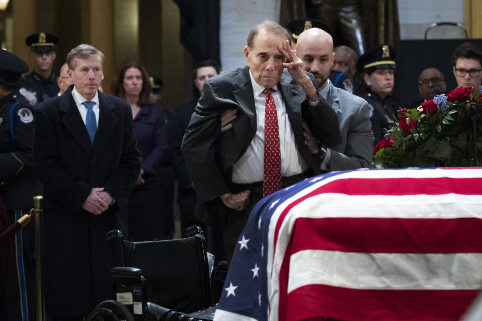 Former Senator Bob Dole stands up and salutes the casket of the late former President George H.W. Bush as he lies in state at the U.S. Capitol, on Dec. 4, 2018.<span class="copyright">Drew Angerer—Getty Images</span>