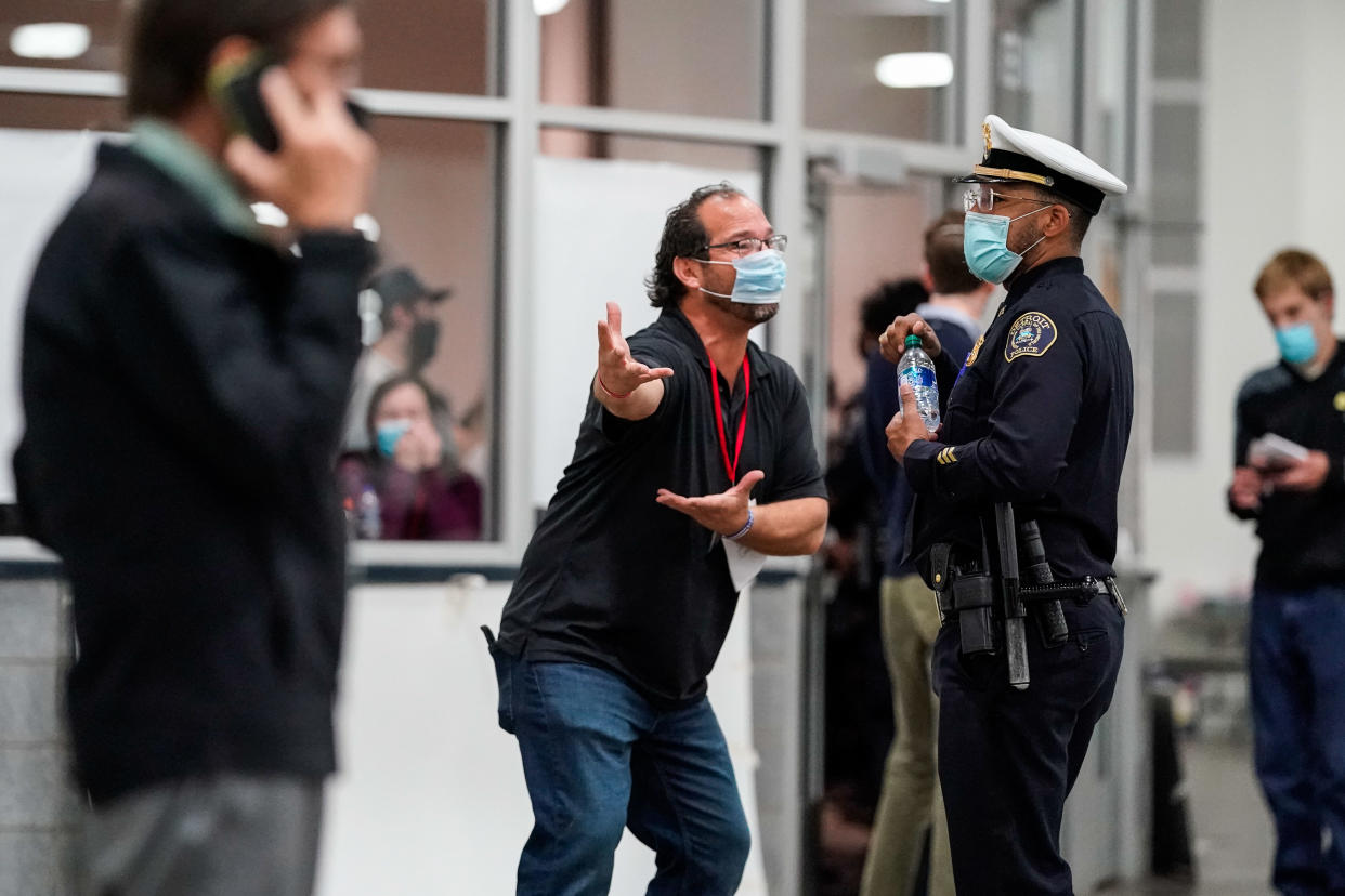 An election challenger gestures to a Detroit Police Captain while arguing that non-partisan election challengers should be allowed access to ballot counting.