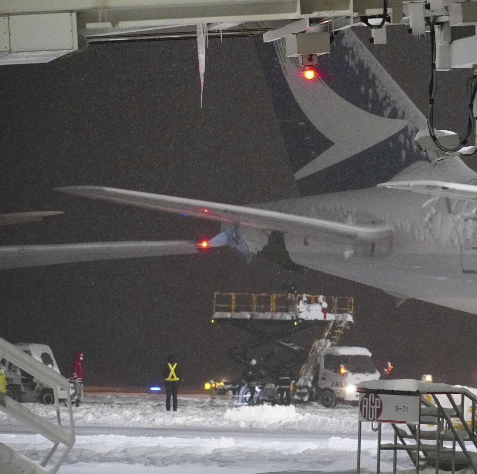 A part of wing of a Korean Air plane, left, and Cathay Pacific aircraft, right, are seen after a collision at northern Japan's New Chitose Airport in Sapporo, Tuesday, Jan. 16, 2024. A Korean Air plane carrying 289 people hit a parked Cathay Pacific aircraft while being pushed by a ground vehicle ahead of takeoff at northern Japan's New Chitose Airport on Tuesday but caused no fire or injuries, fire and airline officials said. (Kyodo News via AP)