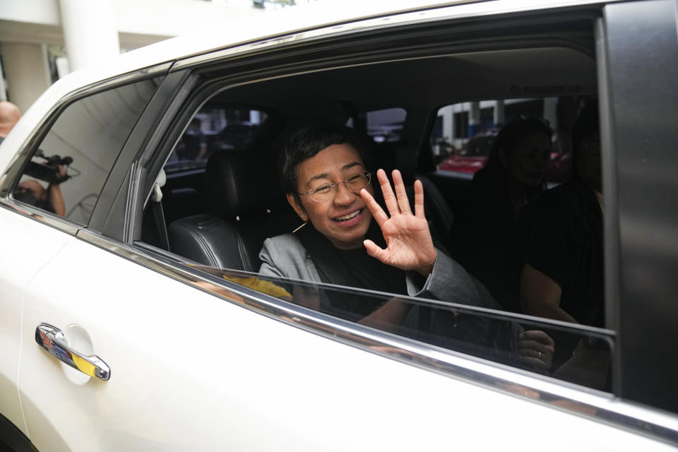 Filipino journalist Maria Ressa, 2021 Nobel Peace Prize winner and Rappler CEO, waves from her car after being acquitted by the Pasig Regional Trial Court over a tax evasion case in Pasig city, Philippines on Tuesday, Sept. 12, 2023. (AP Photo/Aaron Favila)