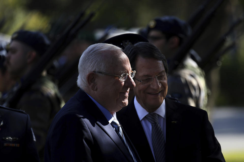 Cyprus' president Nicos Anastasiades and Israel's President Reuven Rivlin, left, review a military guard of honor during a welcoming ceremony at the presidential palace in divided capital Nicosia, Cyprus, on Tuesday, Feb. 12, 2019. Rivlin is in Cyprus for one-day official visit for talks. (AP Photo/Petros Karadjias)