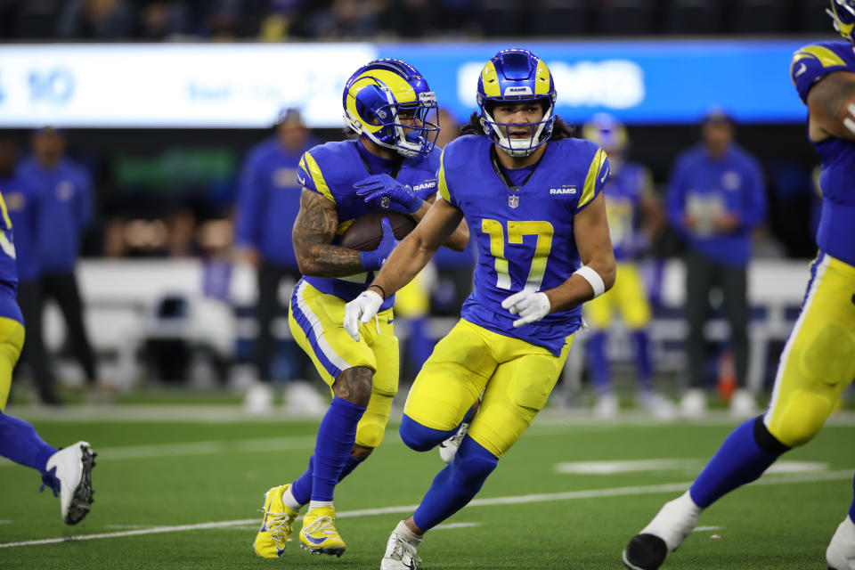 Los Angeles Rams wide receiver Puka Nacua (17) leads block for Los Angeles Rams running back Kyren Williams (23) 