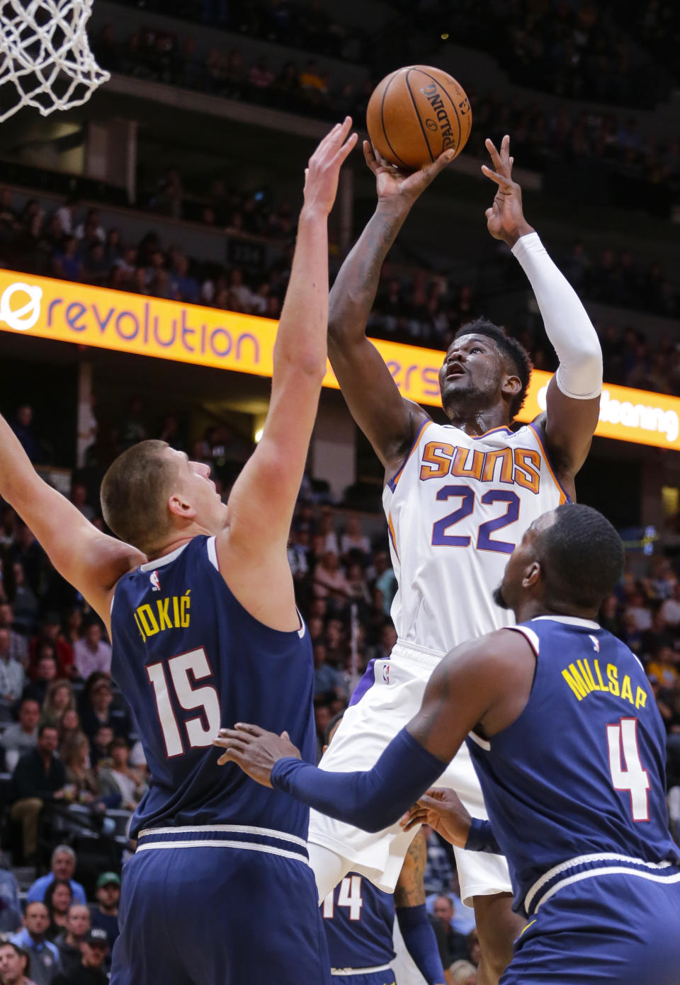 Phoenix Suns center Deandre Ayton (22) shoots over Denver Nuggets center Nikola Jokic (15) and Paul Millsap (4) during the first quarter of an NBA basketball game, Saturday, Oct. 20, 2018, in Denver. (AP Photo/Jack Dempsey)