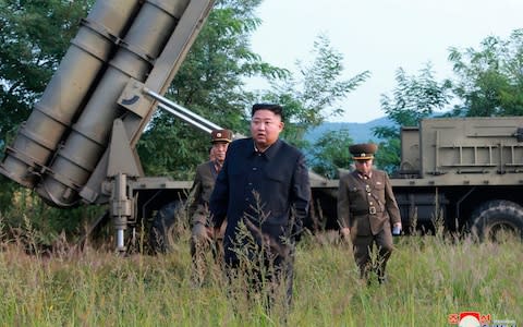 Kim Jong-un inspects the testing of a multiple rocket launcher system in September - Credit: KCNA via KNS/AP