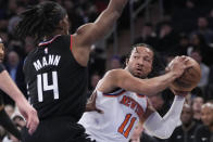 New York Knicks guard Jalen Brunson (11) looks to move the ball around Los Angeles Clippers guard Terance Mann (14) in the first half of an NBA basketball game, Saturday, Feb. 4, 2023, at Madison Square Garden in New York. (AP Photo/Mary Altaffer)
