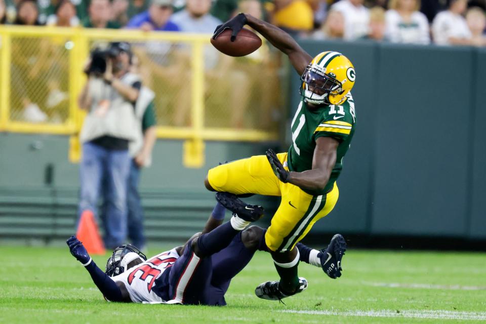 Green Bay Packers' Devin Funchess catches a pass with Houston Texans' Keion Crossen defending during the first half of a preseason NFL football game Saturday, Aug. 14, 2021, in Green Bay, Wis. (AP Photo/Matt Ludtke)