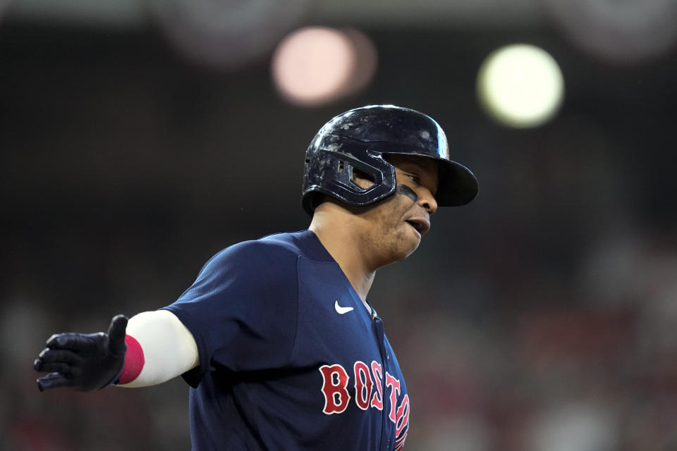 Boston Red Sox's Rafael Devers celebrates after a grand slam home run against the Houston Astros during the second inning in Game 2 of baseball's American League Championship Series Saturday, Oct. 16, 2021, in Houston. (AP Photo/David J. Phillip)