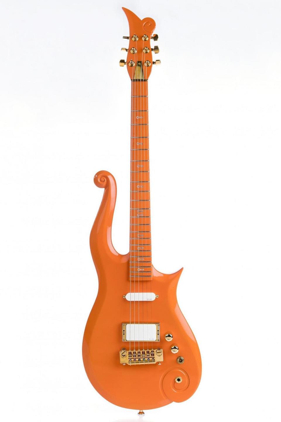 Flying high: Prince's Cloud guitar, in orange, which he played at the Superbowl