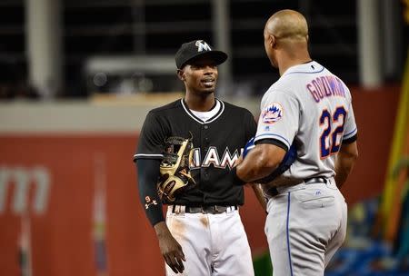 Sep 26, 2016; Miami, FL, USA; Miami Marlins second baseman Dee Gordon (left) talks with New York Mets first base coach Tom Goodwin (right) during the sixth inning at Marlins Park. Mandatory Credit: Steve Mitchell-USA TODAY Sports