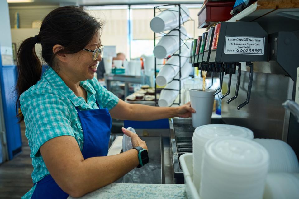 Lyn Yee fills a cup with soda as she fills an order at Phoenix Blue Fin on Central Avenue on Oct. 4, 2022.