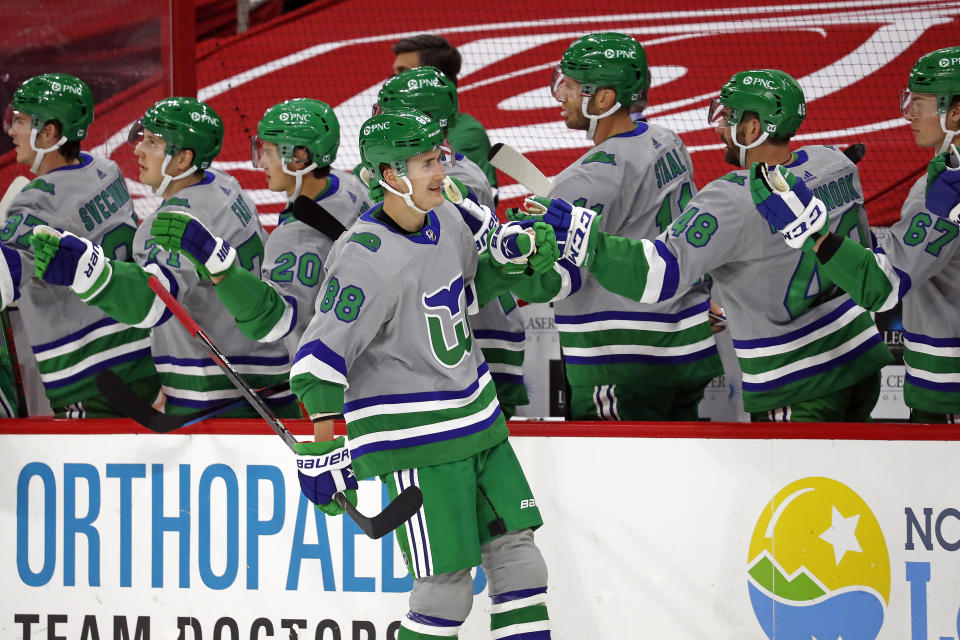 Carolina Hurricanes' Martin Necas (88) is congratulated by teammates on his goal against the Detroit Red Wings during the first period of an NHL hockey game in Raleigh, N.C., Saturday, April 10, 2021. (AP Photo/Karl B DeBlaker)