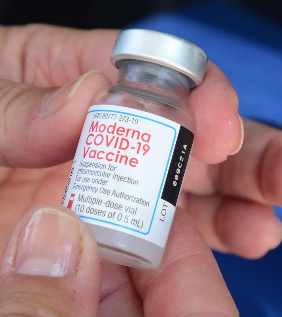 Susan Dubb, RN, BS, prepares a Moderna COVID-19 vaccine shot Monday at a drive-up Uncas Health District Mobile Vaccination Team Monday near the food distribution off Route 2 in Norwich. [John Shishmanian/ NorwichBulletin.com]