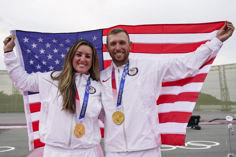 Amber English, left, and Vincent Hancock, both of the United States, celebrate taking the gold medal in the women's and men's skeet at the Asaka Shooting Range in the 2020 Summer Olympics, Monday, July 26, 2021, in Tokyo, Japan. (AP Photo/Alex Brandon)