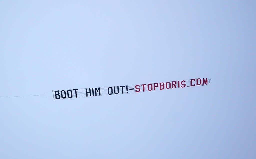 A sign protesting against Prime Minister Boris Johnson is flown over Manchester United’s Premier League match with West Ham at Old Trafford, Manchester (PA) (PA Wire)