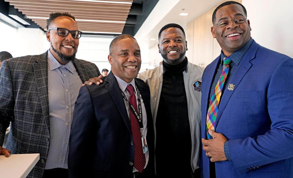 From left, John Daniels III; John R. Tribble, vice president of agency operation and business development; and former Green Bay Packers players LeRoy Butler and George Koonce pose for a photo while attending the opening of Church Mutual Insurance on Tuesday, Oct. 18, 2022, at 833 E. Michigan St.