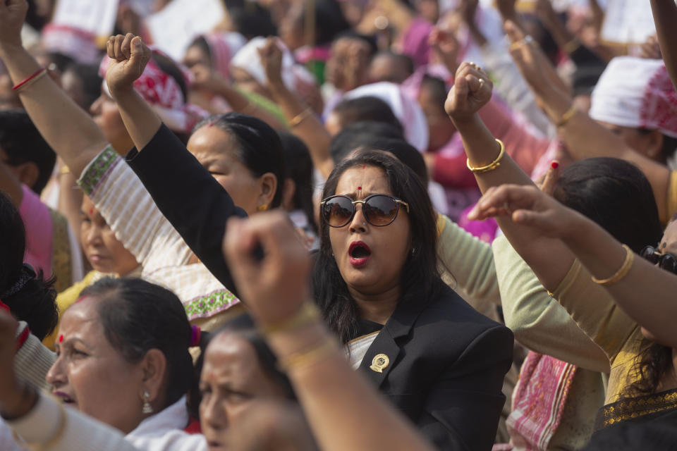 Indian women shout slogans during a protest against the Citizenship Amendment Act in Gauhati, India, Saturday, Dec. 21, 2019. Critics have slammed the law as a violation of India's secular constitution and have called it the latest effort by the Modi government to marginalize the country's 200 million Muslims. Modi has defended the law as a humanitarian gesture. (AP Photo/Anupam Nath)