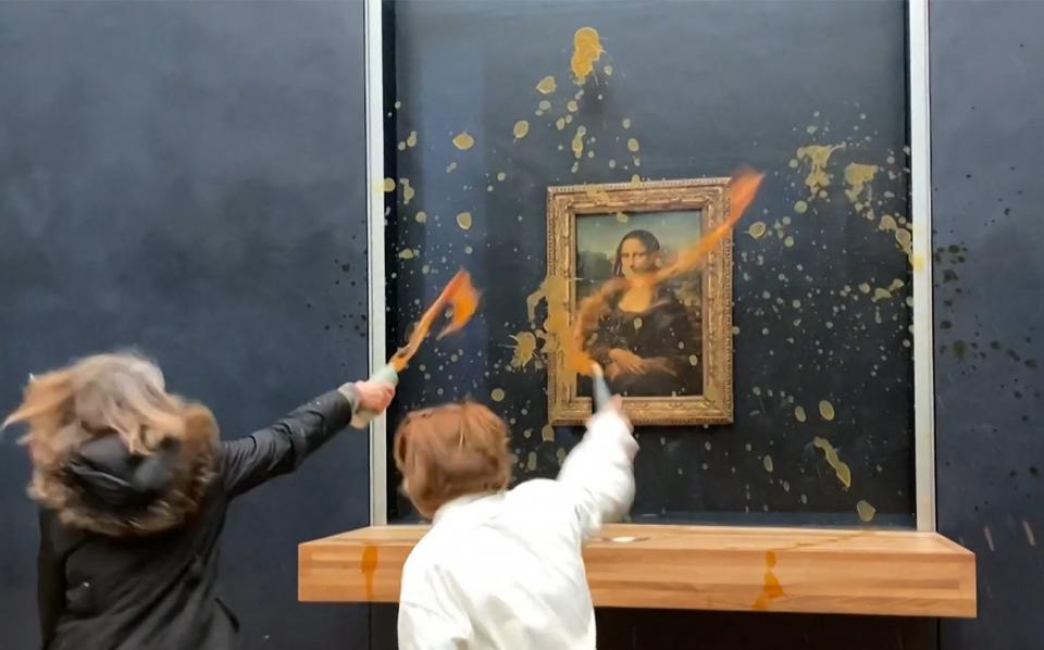 Environmental activists throwing soup at Leonardo Da Vinci's Mona Lisa at the Louvre Museum in Paris