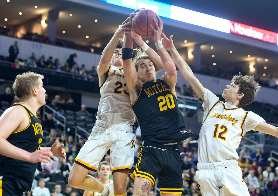 Harrisburg's Maxwell Knutson and Ian Jordan and Mitchell's Caden Hinker collide while jumping for a rebound in the first round of the high school boys state basketball tournament on Thursday, March 17, 2022, at the the Denny Sanford Premier Center in Sioux Falls.