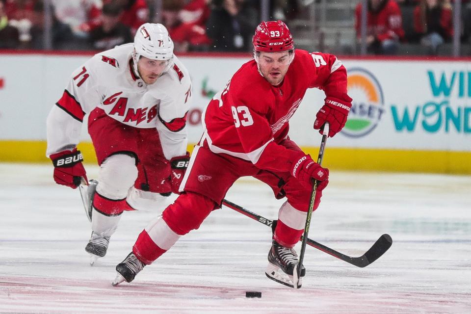 Detroit Red Wings right wing Alex DeBrincat (93) skates against Carolina Hurricanes right wing Jesper Fast (71) during the third period at Little Caesars Arena in Detroit on Thursday, Dec. 14, 2023.