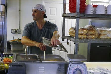 William Luz, who was recently released from the Barnstable County House of Corrections, works as a cook at a restaurant in Sandwich, Massachusetts August 29, 2014. REUTERS/Brian Snyder