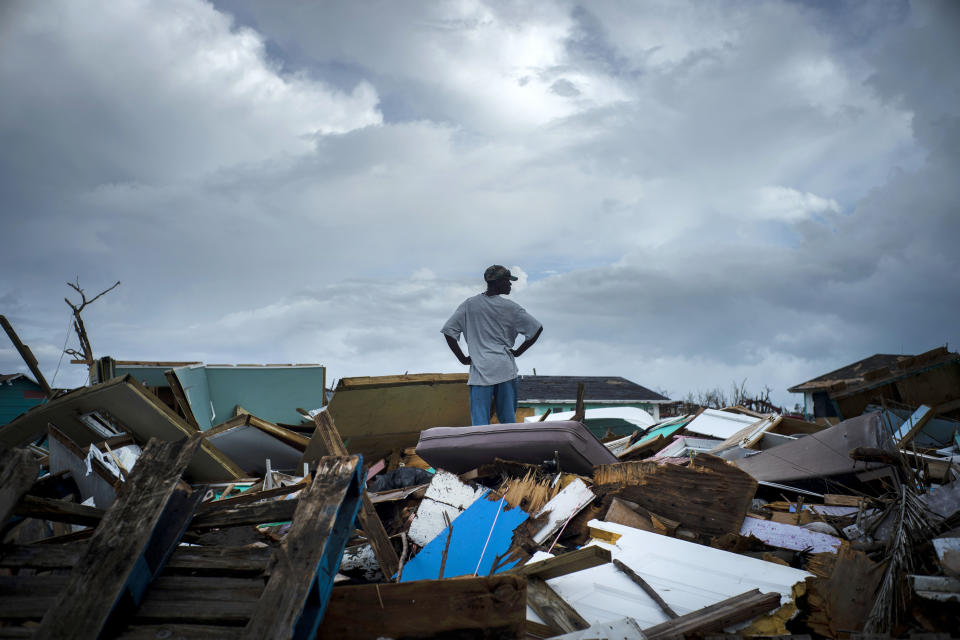 A man stands on the rubble of his home in the Haitian Quarter, after the passage of the Hurricane Dorian in Abaco, Bahamas, Monday, Sept. 16, 2019. Dorian hit the northern Bahamas on Sept. 1, with sustained winds of 185 mph (295 kph), unleashing flooding that reached up to 25 feet (8 meters) in some areas. (AP Photo/Ramon Espinosa)