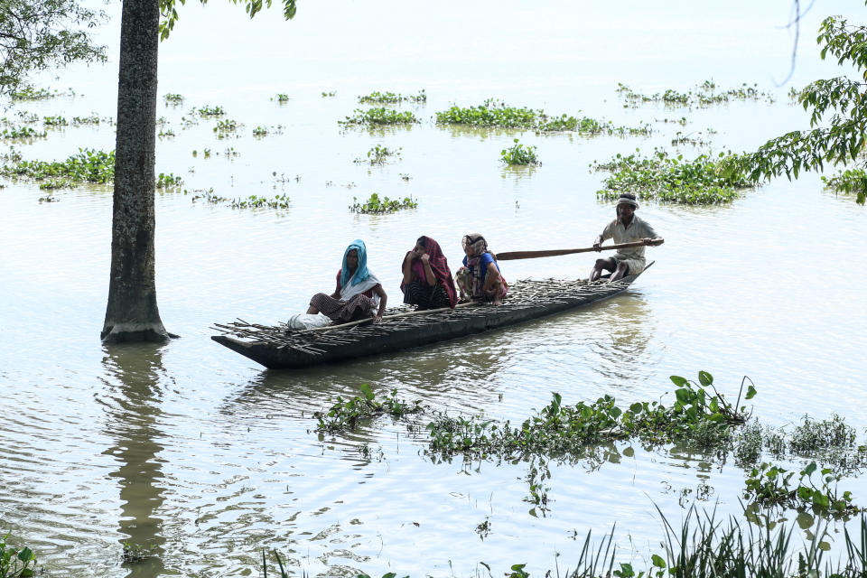 Villagers travel on a boat at the flood affected area of Laibil village in Sibsagar district of Assam, India, on July 22, 2020. (Photo by Dimpy Gogoi/NurPhoto via Getty Images)