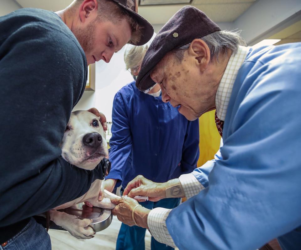 Dr. Gary Tran checks on a patient at his veterinary practice. Tran is 85 years old and still works the night shift at the emergency animal hospital. He can't sell his practice, because "no one wants it." All of his children became engineers.